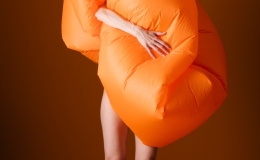 Creative Fashion Concept with Orange Inflatable Outfit