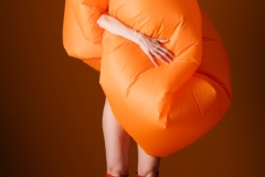 Creative Fashion Concept with Orange Inflatable Outfit