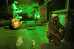 Commuters walk through the Chitral bus Depot, located near the Afghanistan border. CHITRAL, PAKISTAN, 1998. Ⓒ Ed Kashi