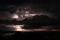 Thunderstorm lightning strike over Moab Utah in desert monsoon rainstorm.